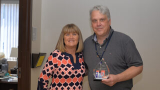 Mary Meliski presenting Scott Beegle, MD, with the Recognizing Excellence in Diagnostics (V-RED) Award, Honorable Mention