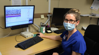 Crystal Charland, RPSGT, registered Polysomnographic Technologist with Albany Med’s Sleep Clinic sitting at computer