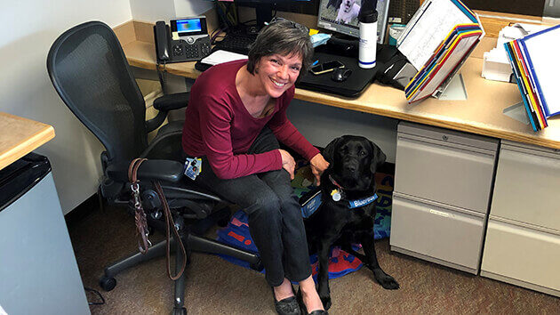 Senior Access Coordinator Aimee Muller, BSN, fosters puppies for organizations like Guiding Eyes for the Blind and Blue Path Autism.