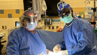 R. Clement Darling, III, MD and a colleague in the operating room, operating on a heart failure patient