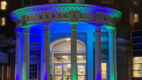 Albany Med entrance lit in blue and green