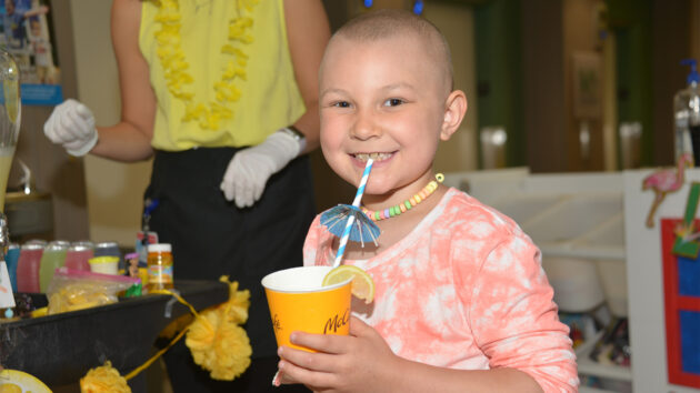 Young girl sipping lemonade, for a summer celebration at the Melodies Center