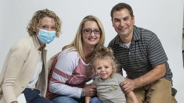 Melodies Center patient Logan Fogg and his parents pose for a picture with Dr. Weintraub