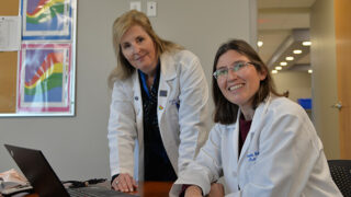 Drs. Jennifer Lindstrom and Danielle Wales pose at a table