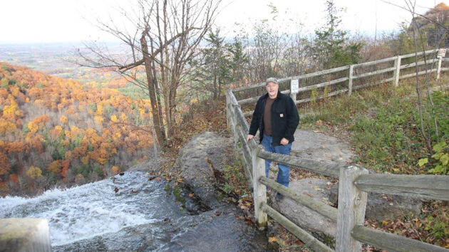 An Alzheimer's patient admires the view at Thatcher Park while on a hike with a medical student,