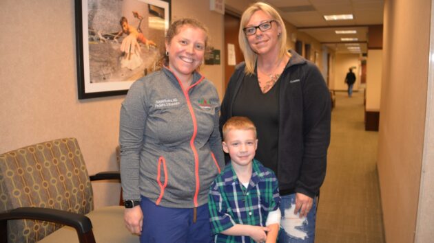 Dr. Abigail Mantica smiles for a picture with Kevin McGuire, a 5-year-old patient, and McGuire's mom, Melissa Heddy
