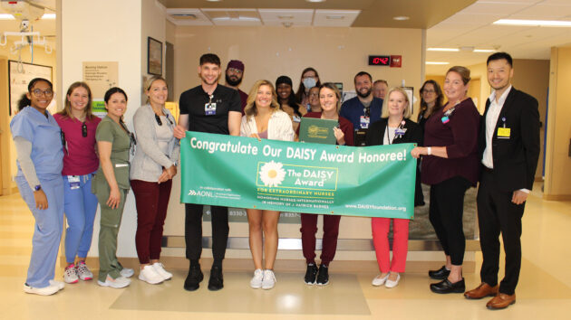 General Surgery and Trauma Unit hold banner for DAISY Award
