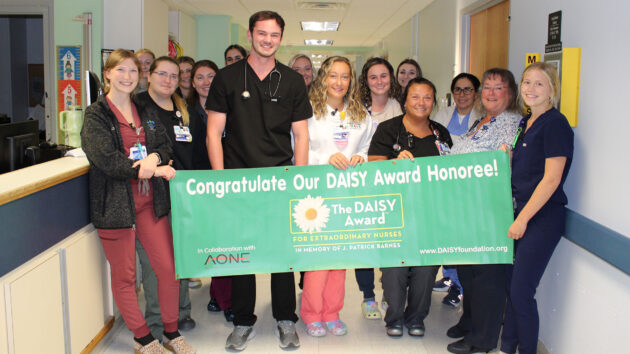 C7 Pediatrics team holds banner for DAISY Award