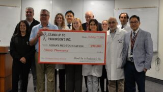 Stand Up to Parkinson's board members present a check to Albany Medical College clinicians, scientists, and students to support research on Parkinson's disease