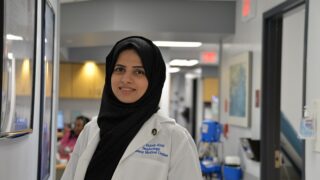 Nephrologist Dr. Sidrah Abid stands in the hall at the nephrology clinic