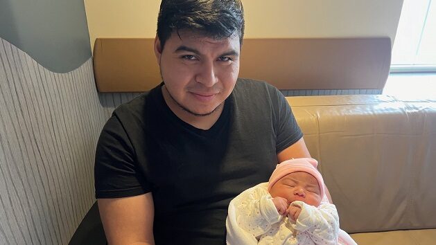 Dad holding newborn baby girl
