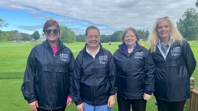 four women volunteering at the golf tournament