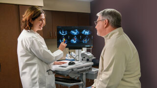 doctor consulting patient with images of heart