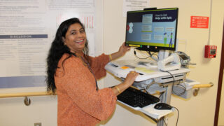Care team member uses Epic on standing computer