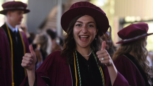 Albany Medical College graduate giving a thumbs-up sign at the 2024 Commencement ceremony