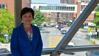 Shelly Breton, SVP for System Revenue Cycle, standing on pedestrian bridge at Albany Medical Center