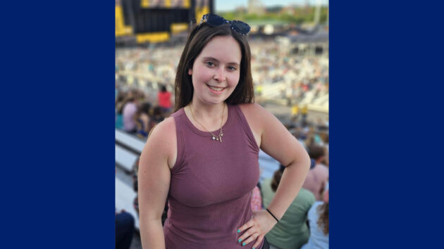 Glomerular disease patient Madison Lee poses at a concert venue in June 2025
