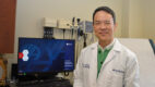 Endocrine surgeon Dr. Joshua Chao wearing a white coat and standing in an exam room