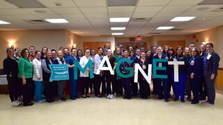 Nurses and other hospital leaders celebrating Magnet surveying