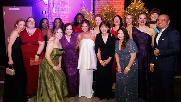 The Melodies Center team gathered for a group photo at the Dancing in the Woods gala.