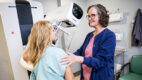 Mammogram tech prepares patient for imaging