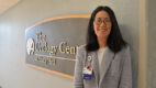 Dr. Lara MacLachlan stands in front of the Urology Center sign at Albany Medical Center