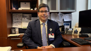 Dr. Jaime Ortiz seated at his desk