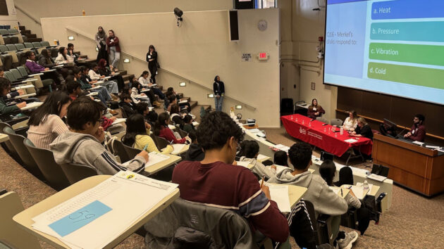 Students sitting in a lecture hall answering multiple choice questions at the 2026 Albany Regional Brain Bee