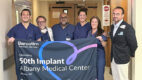 Members of the team that performed the 50th Barostim procedure hold a banner celebrating their milestone.