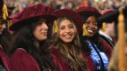 Smiling female graduate at medical school graduation ceremony