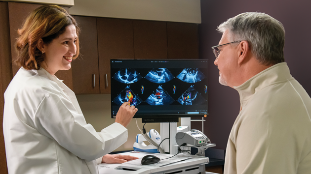 female doctor points to medical images while speaking with man