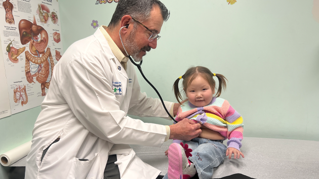 doctor examining little girl