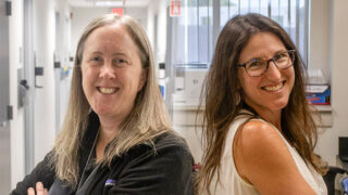 Dr. Cara Grimes and Dr. Kristen Zuloaga stand back-to-back