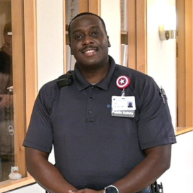 Ayodeji "DJ" Osidele, Public Safety Officer, standing in hallway