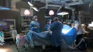 Surgeons in the operating room performing a procedure utilizing the DaVinci 5 Teleprescence technology